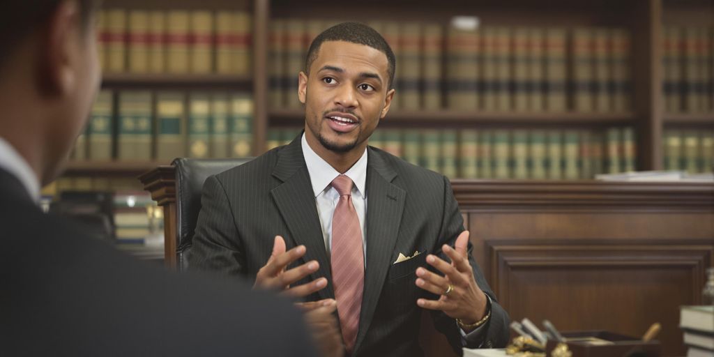 Person speaking to a judge in a courtroom setting.